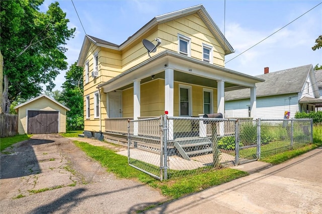 128 Clifford Ave, Rochester, NY 14621 - view of front of home featuring covered porch, asphalt driveway, a detached garage, a fenced front yard, and an outbuilding