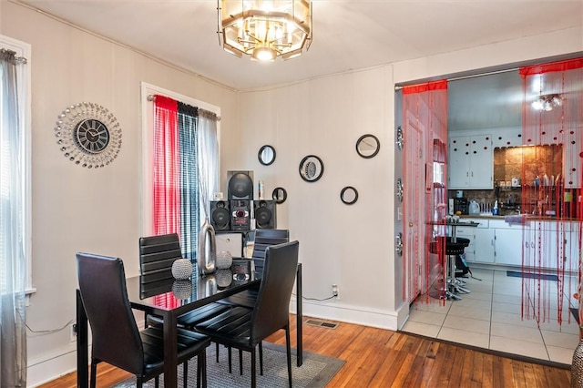 128 Clifford Ave, Rochester, NY 14621 - dining area with a chandelier and wood finished floors