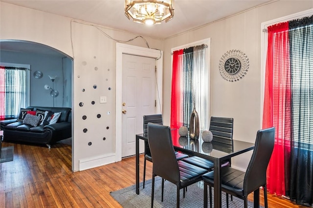 128 Clifford Ave, Rochester, NY 14621 - dining room with arched walkways, hardwood / wood-style floors, and a chandelier