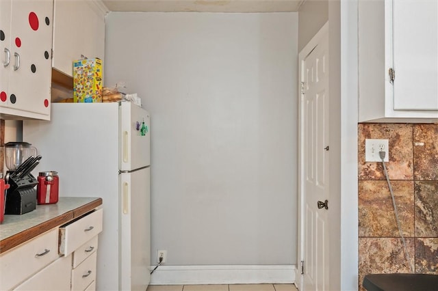 128 Clifford Ave, Rochester, NY 14621 - kitchen featuring light countertops, white cabinetry, freestanding refrigerator, and decorative backsplash