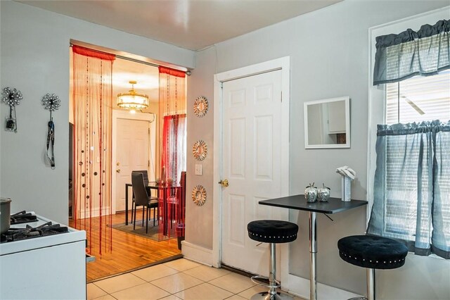 128 Clifford Ave, Rochester, NY 14621 - kitchen featuring white range with gas stovetop, light tile patterned floors, and dark countertops