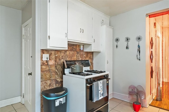 128 Clifford Ave, Rochester, NY 14621 - kitchen featuring white gas range, light tile patterned floors, white cabinets, and decorative backsplash