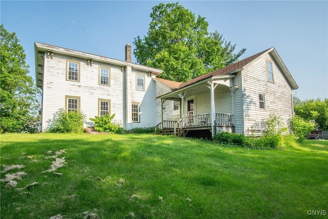 8367 S Main St, Le Ray, NY 13637 - rear view of house featuring a chimney, a porch, and a yard