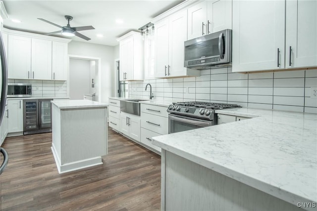 8367 S Main St, Le Ray, NY 13637 - kitchen with appliances with stainless steel finishes, recessed lighting, wine cooler, backsplash, and dark wood-style floors