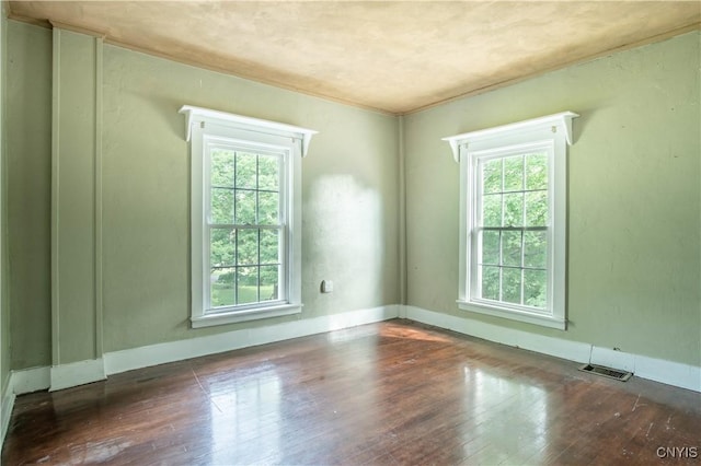 8367 S Main St, Le Ray, NY 13637 - empty room with healthy amount of natural light and hardwood / wood-style floors