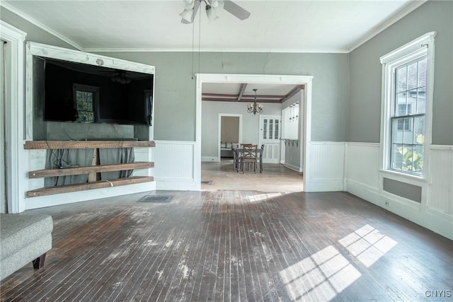 8367 S Main St, Le Ray, NY 13637 - unfurnished living room featuring hardwood / wood-style flooring, wainscoting, a chandelier, ceiling fan, and crown molding
