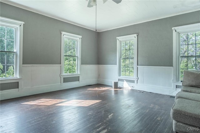 8367 S Main St, Le Ray, NY 13637 - unfurnished room with healthy amount of natural light, a ceiling fan, wainscoting, and hardwood / wood-style floors