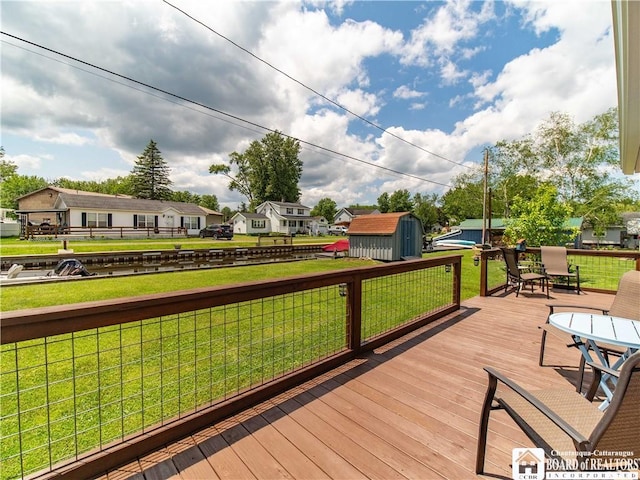 2389 Lakeside Dr, Busti, NY 14710 - wooden deck featuring a storage unit, a fenced backyard, a residential view, and outdoor dining area
