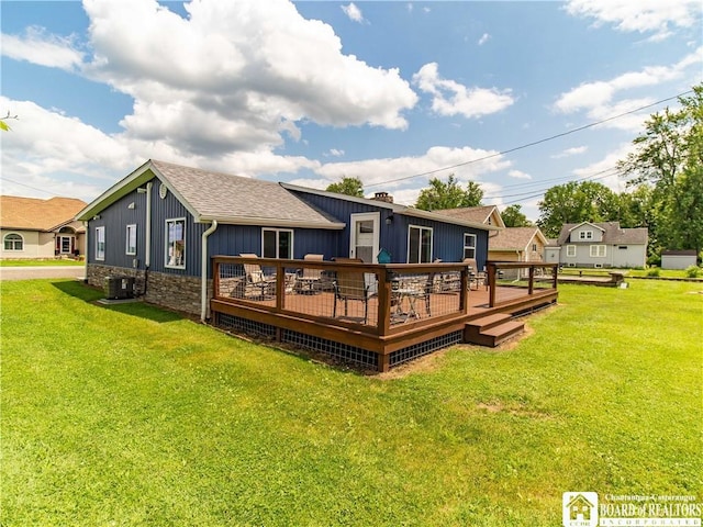 2389 Lakeside Dr, Busti, NY 14710 - rear view of property featuring a deck, a yard, board and batten siding, roof with shingles, and stone siding