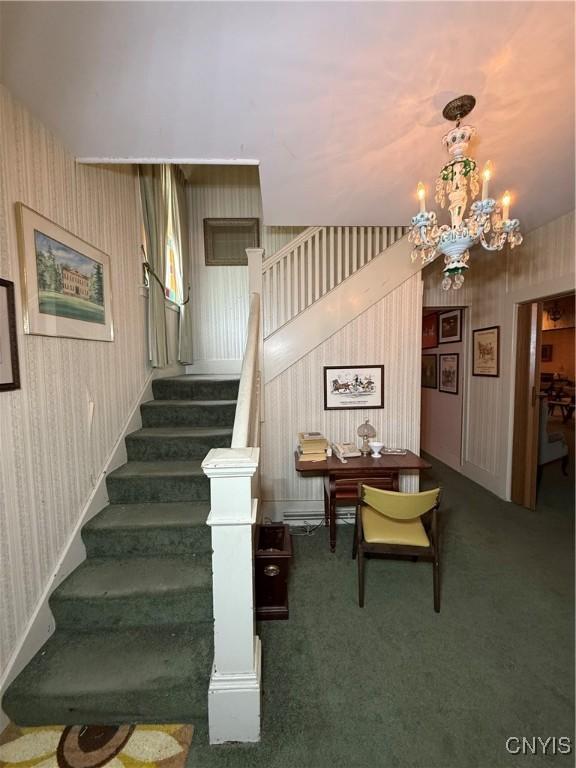 38 Sullivan St, Cazenovia, NY 13035 - stairs with wallpapered walls, a chandelier, and carpet flooring