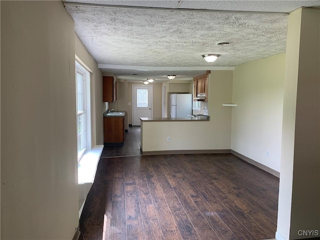 20 Park Ave, Sandy Creek, NY 13083 - unfurnished living room with dark wood-style floors and a textured ceiling