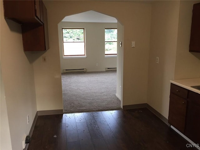 20 Park Ave, Sandy Creek, NY 13083 - kitchen with baseboard heating, arched walkways, dark brown cabinetry, dark colored carpet, and dark wood-style flooring