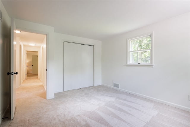 16 Aquarius Ln, Greece, NY 14612 - unfurnished bedroom with light colored carpet and a closet