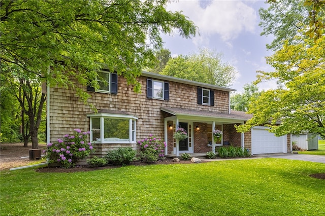 16 Aquarius Ln, Greece, NY 14612 - view of front of house featuring asphalt driveway, a front yard, and a garage