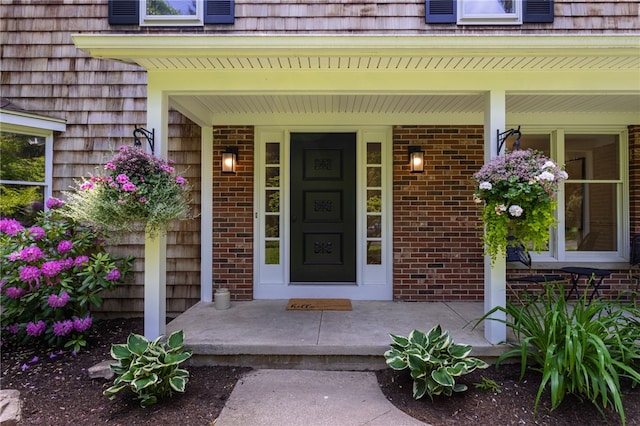 16 Aquarius Ln, Greece, NY 14612 - view of exterior entry with a porch and brick siding