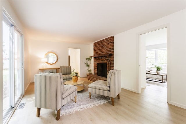 16 Aquarius Ln, Greece, NY 14612 - living room featuring light wood finished floors and a brick fireplace