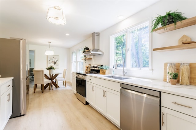 16 Aquarius Ln, Greece, NY 14612 - kitchen with appliances with stainless steel finishes, island range hood, open shelves, light wood finished floors, and recessed lighting