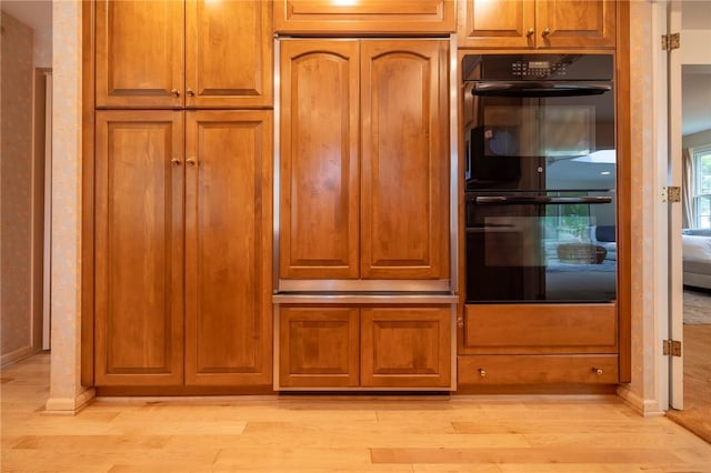 115 Crandon Way, Brighton, NY 14618 - kitchen with light wood-style floors, brown cabinets, and paneled fridge