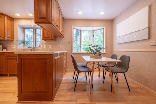 115 Crandon Way, Brighton, NY 14618 - kitchen with brown cabinetry, light wood-style flooring, light countertops, decorative backsplash, and recessed lighting