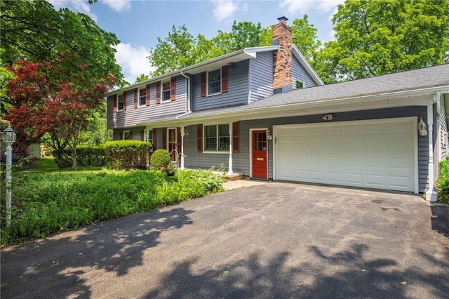 115 Crandon Way, Brighton, NY 14618 - view of front of property featuring a garage, asphalt driveway, a chimney, and a porch