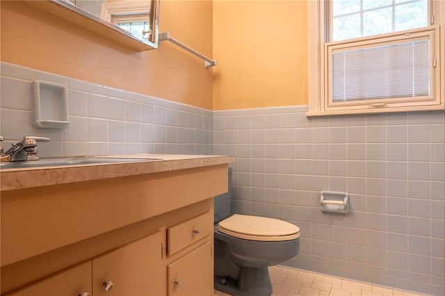 115 Crandon Way, Brighton, NY 14618 - half bath with tile walls, vanity, a wainscoted wall, and tile patterned flooring