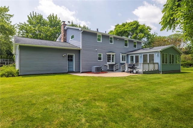 115 Crandon Way, Brighton, NY 14618 - back of property with a patio area, a chimney, a yard, and a sunroom