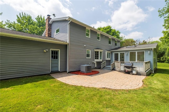 115 Crandon Way, Brighton, NY 14618 - back of property with a chimney, a deck, a patio area, and a yard