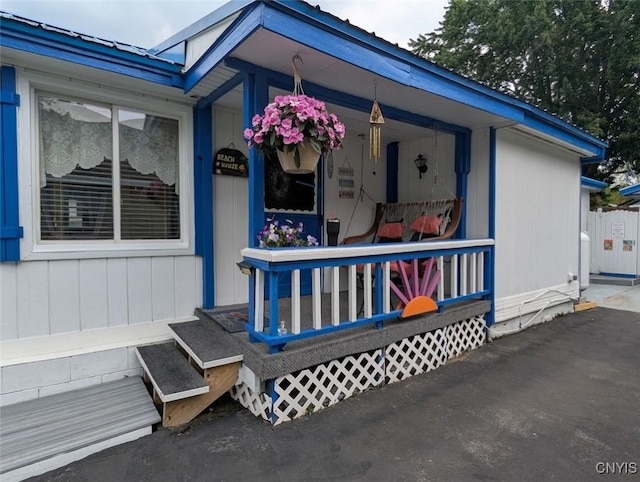 2008 Main St, Vienna, NY 13157 - property entrance with covered porch and a metal roof