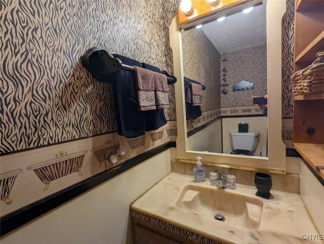 2008 Main St, Vienna, NY 13157 - half bathroom with wallpapered walls, vanity, and a textured ceiling