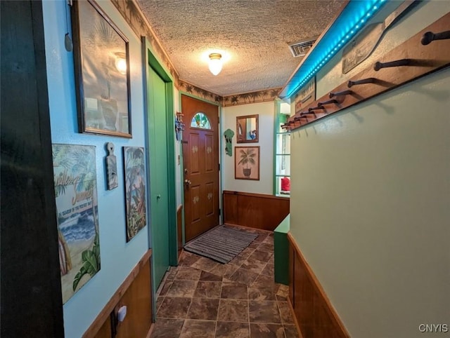 2008 Main St, Vienna, NY 13157 - entryway featuring a textured ceiling, wainscoting, and wooden walls