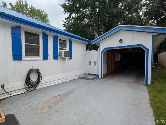2008 Main St, Vienna, NY 13157 - view of side of home featuring concrete driveway, an outbuilding, a metal roof, and cooling unit