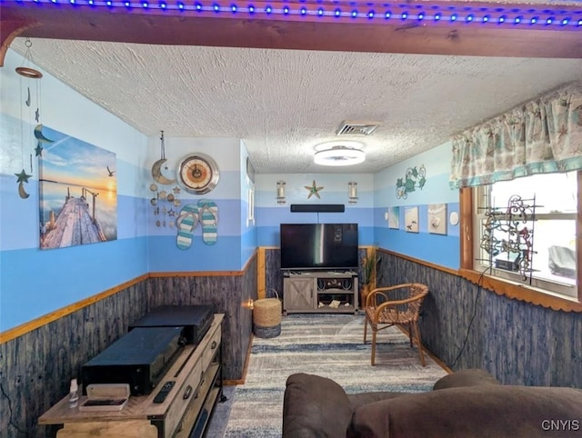 2008 Main St, Vienna, NY 13157 - living area featuring wainscoting, a textured ceiling, carpet flooring, and wood walls