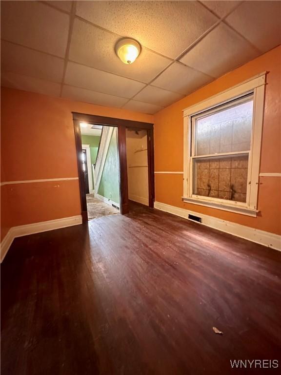 524 10th St, Niagara Falls, NY 14301 - spare room featuring a drop ceiling and wood finished floors