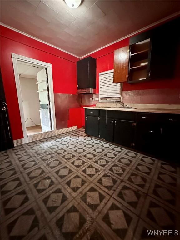 524 10th St, Niagara Falls, NY 14301 - kitchen featuring light countertops, tile patterned floors, and dark cabinets
