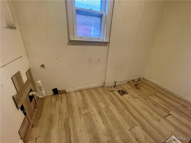 524 10th St, Niagara Falls, NY 14301 - laundry room featuring light wood-type flooring and baseboards