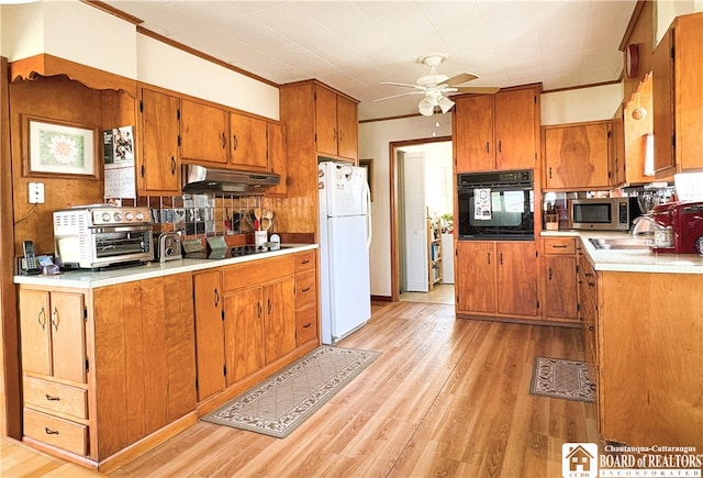2411 Lakeside Dr, Busti, NY 14710 - kitchen with black appliances, extractor fan, brown cabinets, light wood-type flooring, and ceiling fan