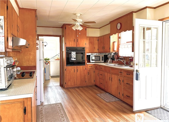 2411 Lakeside Dr, Busti, NY 14710 - kitchen featuring oven, ventilation hood, light countertops, stainless steel microwave, and crown molding