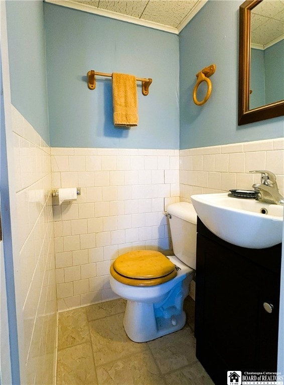 2411 Lakeside Dr, Busti, NY 14710 - bathroom featuring tile walls, vanity, a wainscoted wall, and tile patterned floors