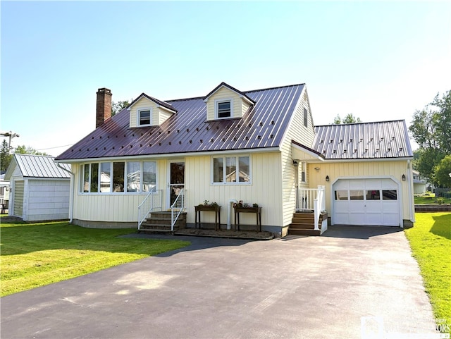 2411 Lakeside Dr, Busti, NY 14710 - view of front of property with a garage, a metal roof, a chimney, and a front lawn