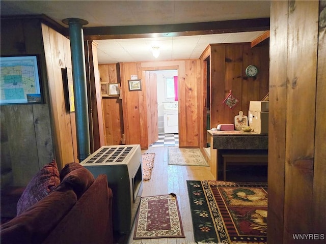 911 Shoreham St, Carlton, NY 14571 - living area with wood finished floors, wooden walls, and washer / dryer