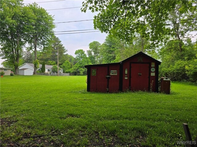 911 Shoreham St, Carlton, NY 14571 - view of green lawn with a storage shed