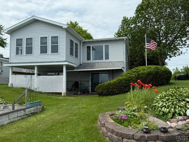 27217 Three Mile Point Rd, Lyme, NY 13622 - rear view of property featuring a yard