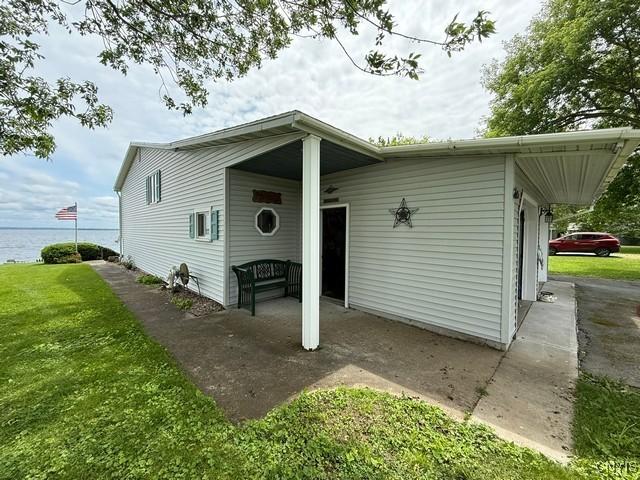 27217 Three Mile Point Rd, Lyme, NY 13622 - view of front of house with a front yard and a water view