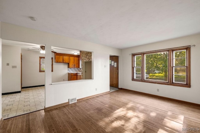 446 77th St, Niagara Falls, NY 14304 - unfurnished living room featuring wood finished floors and ceiling fan