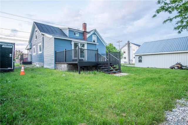 8430 Willow St, Le Ray, NY 13637 - rear view of house featuring a chimney, a deck, and a lawn