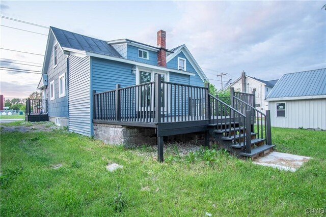 8430 Willow St, Le Ray, NY 13637 - back of house with a deck, a chimney, and a lawn