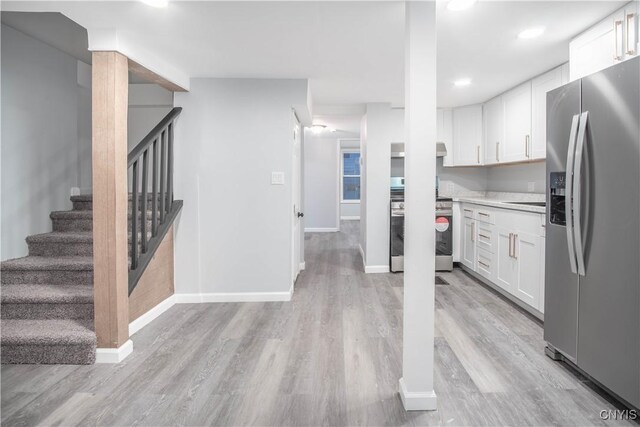 8430 Willow St, Le Ray, NY 13637 - kitchen featuring appliances with stainless steel finishes, white cabinets, light wood-style floors, light countertops, and recessed lighting