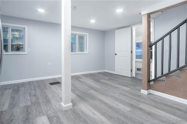 8430 Willow St, Le Ray, NY 13637 - basement featuring wood finished floors, stairs, and recessed lighting
