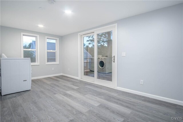 8430 Willow St, Le Ray, NY 13637 - unfurnished room featuring washer / dryer, plenty of natural light, and wood finished floors
