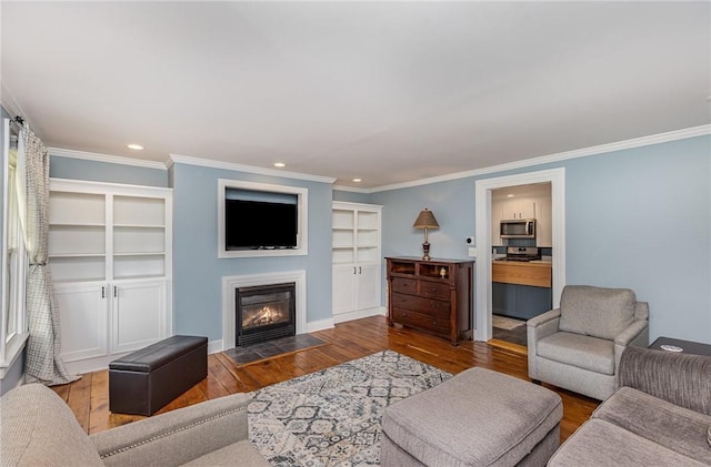 351 Jefferson Ave, Perinton, NY 14450 - living area with hardwood / wood-style flooring, recessed lighting, a fireplace with flush hearth, crown molding, and built in features